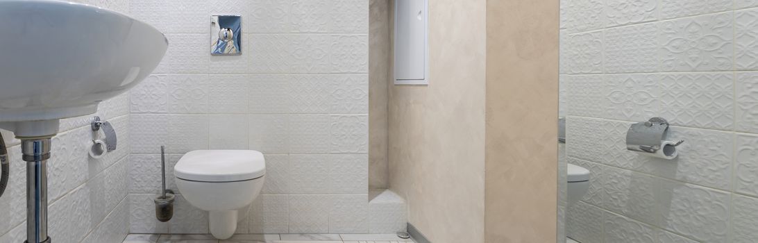 Interior of a modern bright bathroom with a sink and toilet