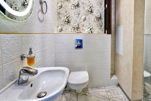 Interior of a modern bright bathroom with a sink and toilet