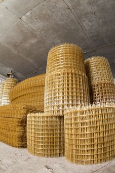 Production of fiberglass mesh reinforcement for construction work.