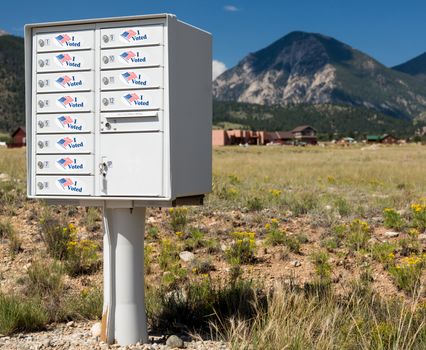 Metal mailbox container for rural homes with I Voted stickers as concept for voting by mail or absentee ballot paper