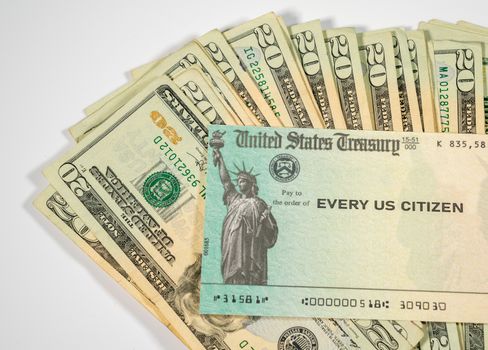Stack of 20 dollar bills with US Treasure illustrative check to illustrate coronavirus stimulus payment on white background