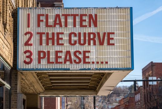 Concept illustration of movie cinema billboard with flatten the curve, please, message to help healthcare workers deal with the coronavirus epidemic.