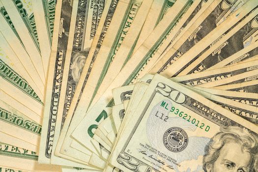 Thousands of US dollars laid out in a fan shape with 20 dollar bills