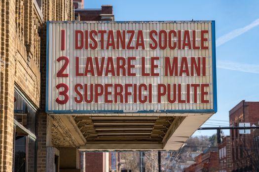 Italian movie cinema billboard with three rules to avoid the coronavirus epidemic. Translation, wash hands, maintain social distance, clean surfaces