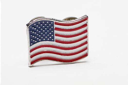 Small united state flag pin against a white background