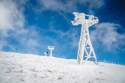 Pillar of a ski lift on a background of blue sky.