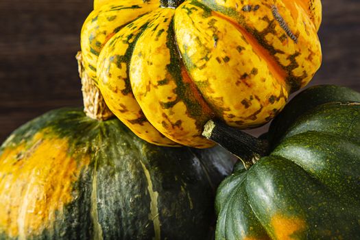 close up of three winter squash against a wood background