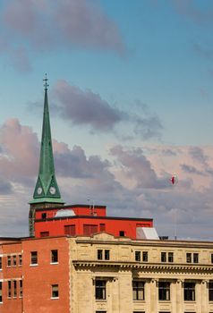 Old Green steeple on church under dark, stormy skies in Saint John, New Brunswick, Canada
