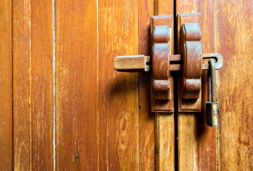 Wooden cabinet door and lock at the handle