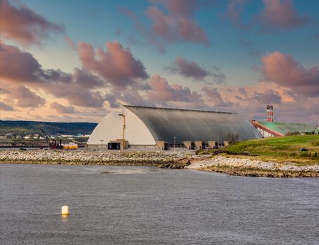 A metal warehouse at an industrial port on the coast of Canada