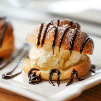 Profiterole, a filled French choux pastry ball with a typically sweet and moist filling of Vanilla Ice Cream, Salted Caramel, Chocolate Sauce