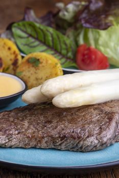 white asparagus on a grilled steak