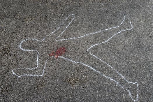 outline of a body on asphalt