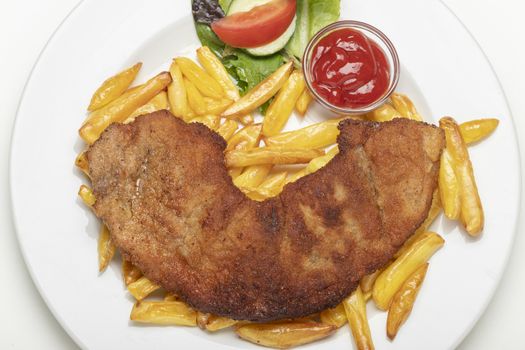 wiener schnitzel with french fries on a plate