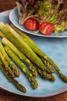grilled green asparagus on a blue plate