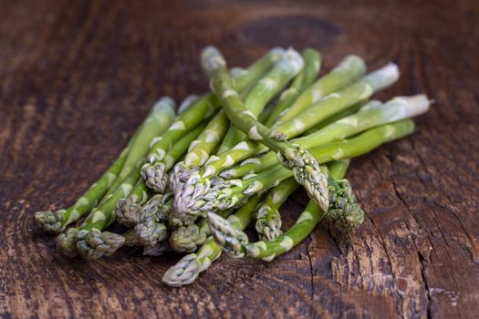 fresh green asparagus on dark wood