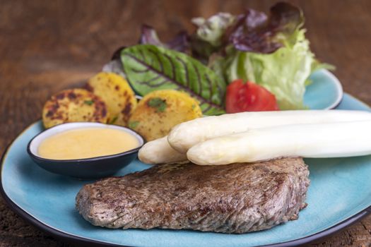 white asparagus on a grilled steak