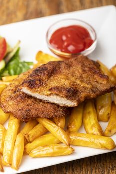 wiener schnitzel with french fries on a plate