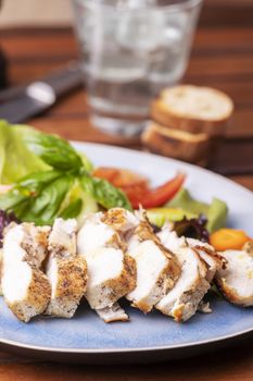 chicken breast slices on fresh salad