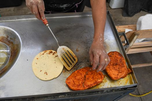 Photo of two hands preparing a typical mexican dishes