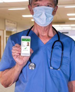 Male doctor concept of immunity testing and certification on smartphone app to allow people to go back to work after negative test