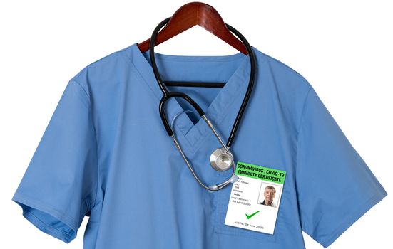 Blue medical scrubs uniform shirt on a hanger with stethoscope and badge for coronavirus immunity certificate