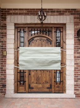 Medical Face Mask Covering Front Door of House.