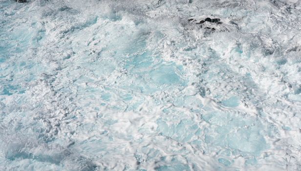 Foaming water on the shoreline of Ka'ena Point on the extreme west coast of Oahu in Hawaii