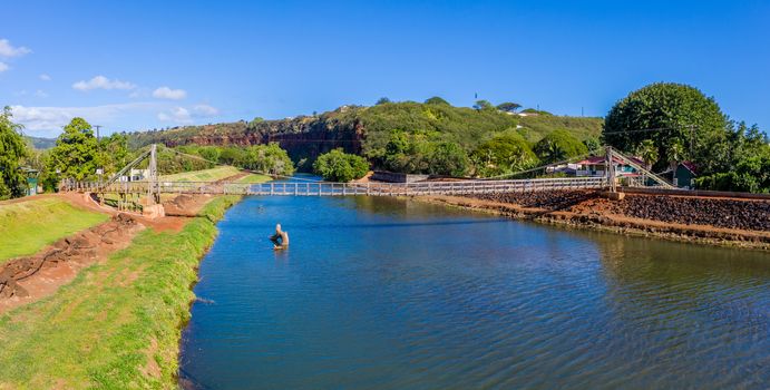 Aerial drone view of the wooden swinging bridge of Hanapepe over the river on Kauai