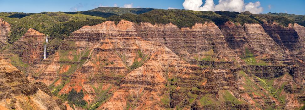 Broad panorama of the red rocks of Waimea canyon from the Waipo'o Falls overlook on Kauai in Hawaii