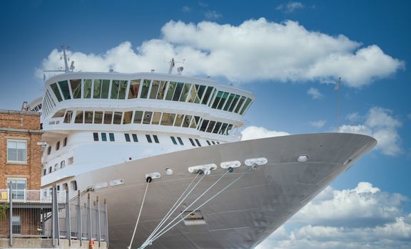 A white luxury cruise ship tied to a pier in Halfiax, Nova Scotia