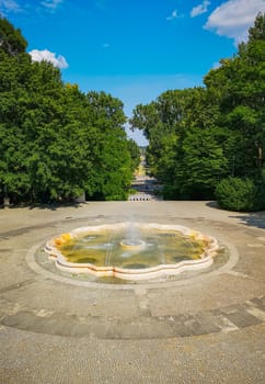 Fountain square with long pathway with concrete pavement