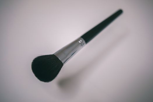 Makeup brushes set on white background ,beneath it you can see the shadow as if it were levitating