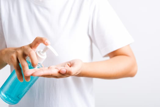 Closeup Hand Asian young woman applying pump dispenser sanitizer alcohol gel on hand wash cleaning, hygiene prevention COVID-19 or coronavirus protection concept, isolated on white background