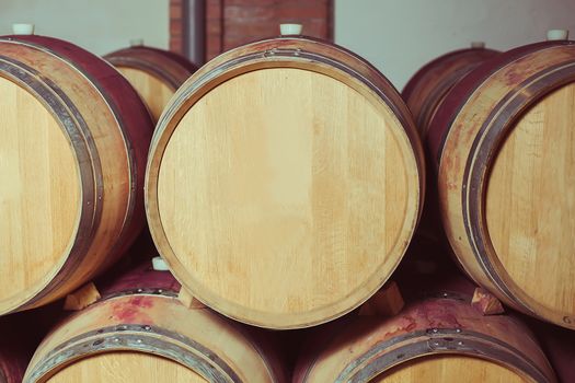 Stacked oak wine barrels in winery cellar