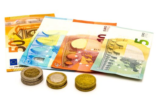 Pile of euro banknotes and coins isolated on white background with clipping path