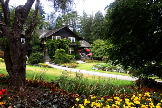 Canada Parks Houses. Countryside barn on dirt road with large trees on sides. Agriculture