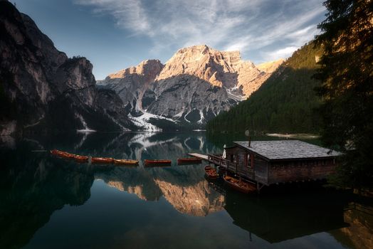 amazing view of braies lake with wooden boats on the water, surrounded by dolomites mountains. Trentino alto adige, Italy on the water, surrounded by dolomites mountains. Trentino alto adige, Italy