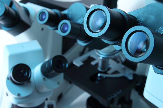 Group of various Microscopes in blue medicine light microbiology research concept