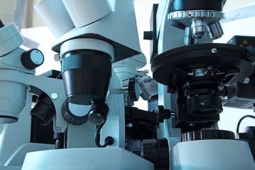 Group of various Microscopes in blue medicine light microbiology research concept