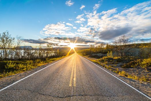 Driving a car on mountain road. Road among mountains and fjord with dramatic stormy cloudy sky. Landscape. Beautiful nature of Norway.