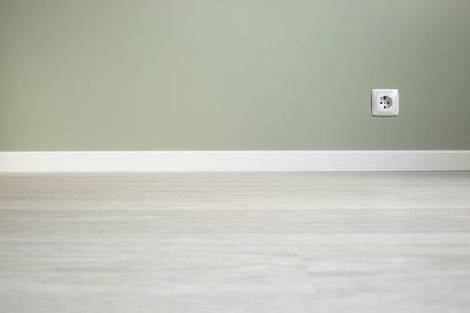 Empty wall and floor background of scandinavian room interior with white plinth and socket close up , copy space for text , renovation , new home ownership concept