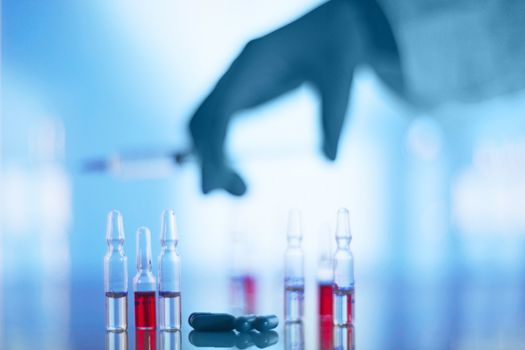 Medical syringe and vials on table in hospital