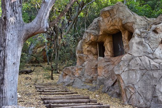 A stone camouflaged outdoors bunker cabin in the woods, Rustenburg, South Africa