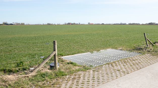 Cattle grid in ground, an obstacle used to prevent wild cattle and other wildlife from crossing