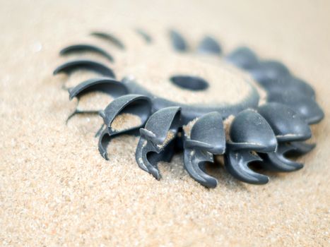 Old water turbine on dried sand with out water, useless in drought condition