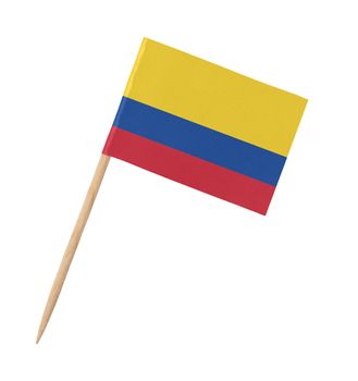 Small paper Colombian flag on wooden stick, isolated on white