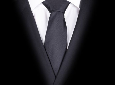 Man in a black suit with black tie, close-up