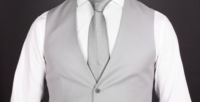 Man in a grey suit with silver tie, close-up