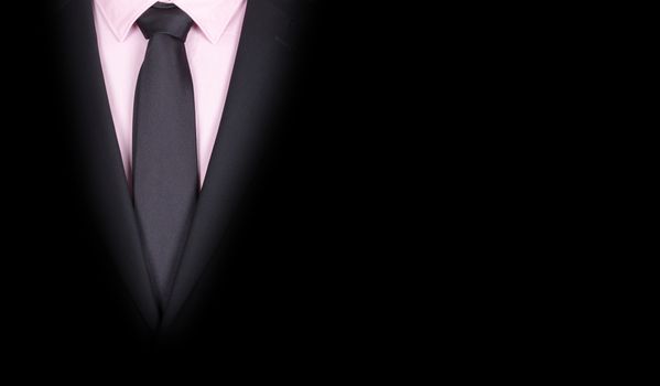 Man in a black suit with black tie, close-up